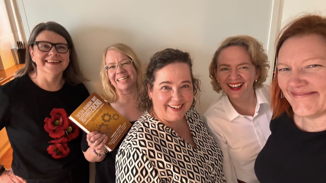 Five women in Helsinki with a copy of the book.